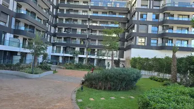 a large apartment building with a garden in front of it at aeria mall studio en plein casa in Casablanca