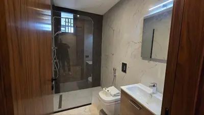 a bathroom with a shower and a toilet and a sink at aeria mall studio en plein casa in Casablanca