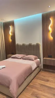 a bedroom with a bed with two lights on the wall at Suite luxueuse proche de Cheikh Zayed & CFC in Casablanca