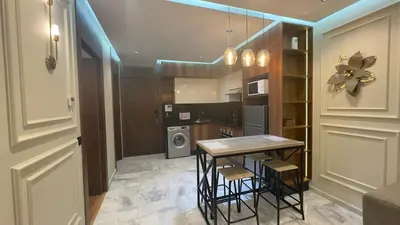 a kitchen with a table and chairs in a room at Suite luxueuse proche de Cheikh Zayed & CFC in Casablanca