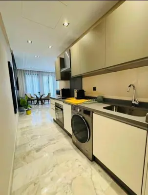 a kitchen with a sink and a dishwasher at Les Joyeux Luxury Studios et Suites in Casablanca