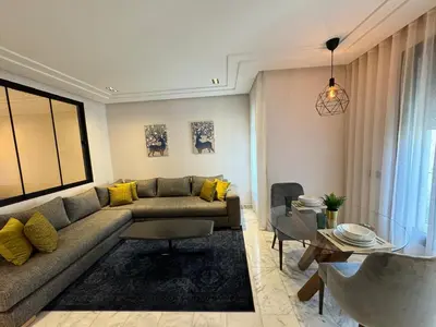 a living room with a couch and a table at Les Joyeux Luxury Studios et Suites in Casablanca