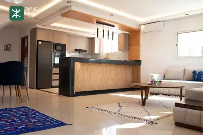 a kitchen and living room with a couch and a table at Beachside Retreat Rabat - Zayane Homes in Temara