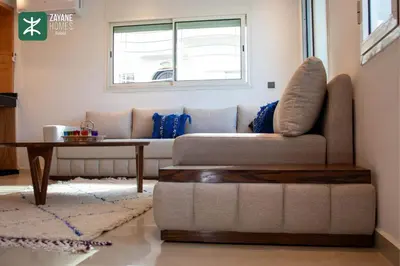 a living room with a couch and a table at Beachside Retreat Rabat - Zayane Homes in Temara