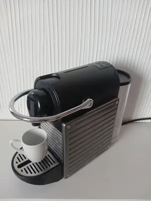a coffee maker with a cup on a stand at Appartement Lumineux Front de Mer à CASABLANCA in Casablanca