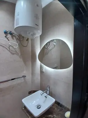 a bathroom with a sink and a mirror at Appartement Lumineux Front de Mer à CASABLANCA in Casablanca