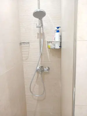 a shower with a shower head in a bathroom at Appartement Lumineux Front de Mer à CASABLANCA in Casablanca