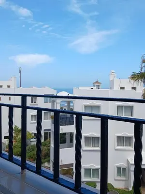 a balcony with a view of a building at Appartement Lumineux Front de Mer à CASABLANCA in Casablanca