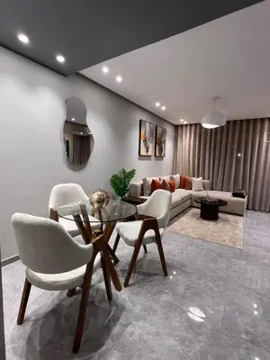 a living room with a glass table and chairs at Appartement à Casablanca Ferme bretonne OCP à 5min du CFC in Casablanca