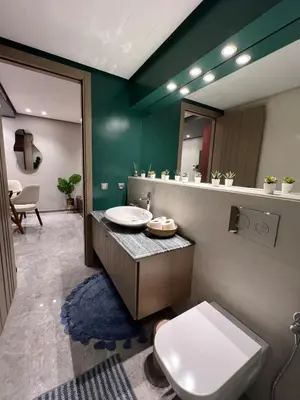 a bathroom with a toilet and a sink and a mirror at Appartement à Casablanca Ferme bretonne OCP à 5min du CFC in Casablanca