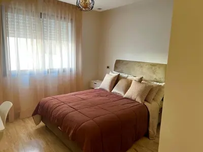 a bedroom with a bed with a red blanket and a window at Appartement centre de casablanca in Casablanca