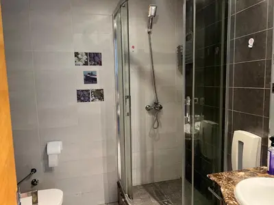 a bathroom with a shower and a toilet and a sink at Appartement centre de casablanca in Casablanca