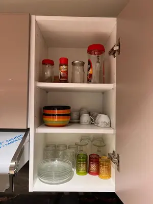 a cabinet filled with dishes and jars of food at Studio de luxe in Casablanca