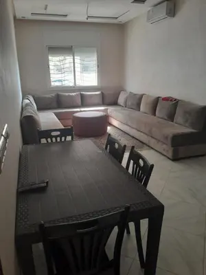 a living room with a couch and a table at Dahomy bouzni9a in Bouznika