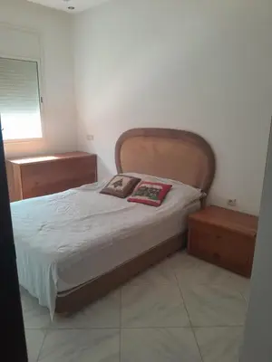 a bed with two pillows on it in a bedroom at Dahomy bouzni9a in Bouznika
