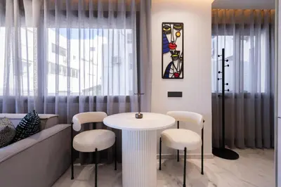 a dining room with a table and stools at Premium Stay - Promenade Hassan II in Casablanca