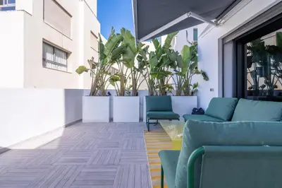 a patio with blue chairs and plants in a building at Premium Stay - Promenade Hassan II in Casablanca