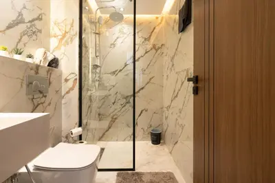 a bathroom with a toilet and a glass shower at Premium Stay - Promenade Hassan II in Casablanca