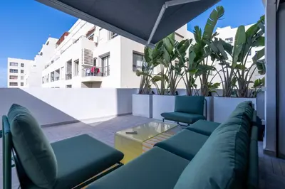 a balcony with blue chairs and a glass table at Premium Stay - Promenade Hassan II in Casablanca