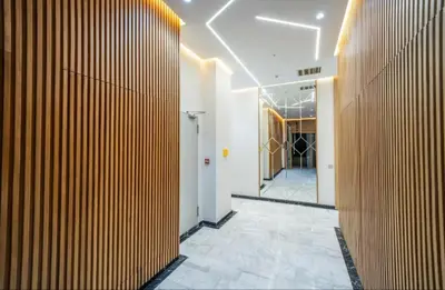 a hallway with a wooden wall in a building at Luxury & sweet studio apartment with swimming pool in Aïn Harrouda