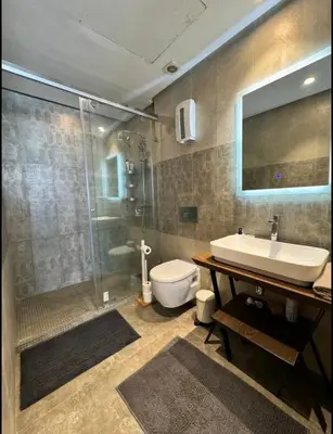 a bathroom with a sink and a shower and a toilet at Résidence Saphir Luxury apartment with terrace in Racine in Casablanca