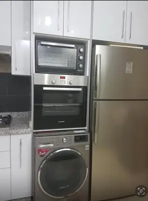 a microwave and a refrigerator in a kitchen at Rabat prestigia hayriad in Rabat
