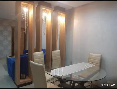 a dining room with a glass table and white chairs at Rabat prestigia hayriad in Rabat