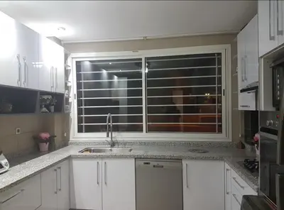 a kitchen with a sink and a large window at Rabat prestigia hayriad in Rabat