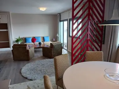a living room with a white table and chairs at Spacious Apartment In CIL Casablanca in Casablanca