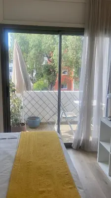 a bedroom with a large window and a yellow rug at Spacious Apartment In CIL Casablanca in Casablanca