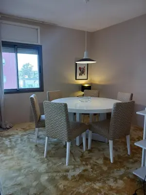 a dining room with a white table and chairs at Spacious Apartment In CIL Casablanca in Casablanca