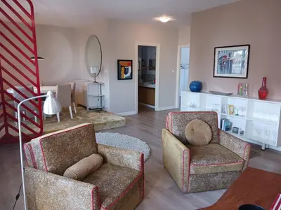 a living room with two chairs and a mirror at Spacious Apartment In CIL Casablanca in Casablanca