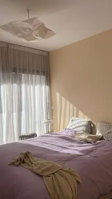a bedroom with a bed with purple sheets and a window at Spacious Apartment In CIL Casablanca in Casablanca