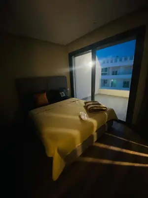 a bedroom with a bed and a large window at Atlantic Suite View 4 in Casablanca