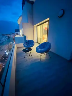 two blue chairs sitting on top of a building at Atlantic Suite View 4 in Casablanca