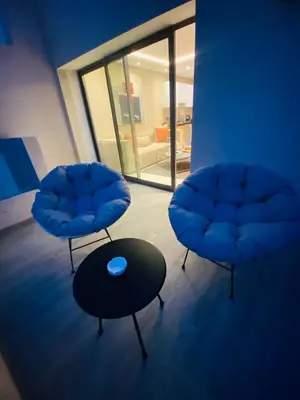 two blue chairs and a table in a room at Atlantic Suite View 4 in Casablanca