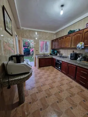 a large kitchen with a sink and a counter at Villa spacieuse avec piscine proche aéroport Mohamed V in Nouaseur