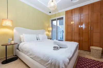a bedroom with a large white bed and a table at Prestige Penthouse Style and Serenity Rabat by MERAT HOME in Rabat