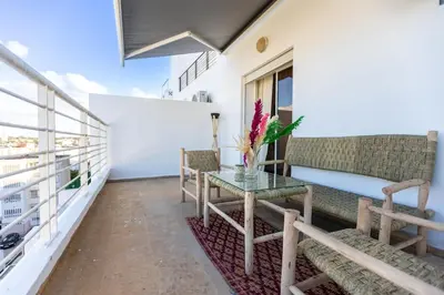 a balcony with a table and chairs on a building at Prestige Penthouse Style and Serenity Rabat by MERAT HOME in Rabat