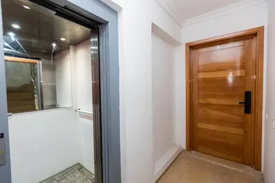 a hallway with a wooden door in a house at Prestige Penthouse Style and Serenity Rabat by MERAT HOME in Rabat