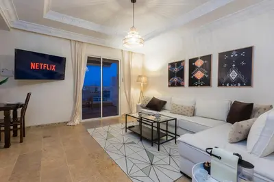 a living room with a white couch and a table at Prestige Penthouse Style and Serenity Rabat by MERAT HOME in Rabat
