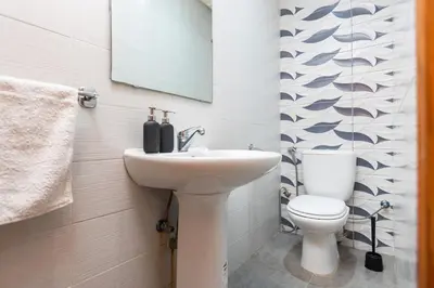 a bathroom with a sink and a toilet at Prestige Penthouse Style and Serenity Rabat by MERAT HOME in Rabat