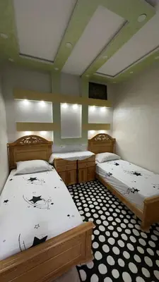two twin beds in a room with at Spacious apartment in Settat