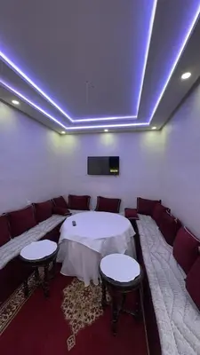 a room with couches and a tv on the ceiling at Spacious apartment in Settat