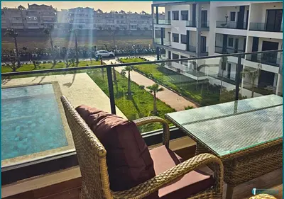 a balcony with a table and chairs and a view of a city at Une petite parenthèse marine in Mansouria