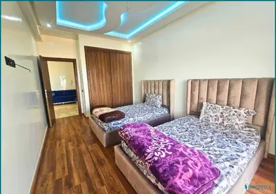 a bedroom with two beds with purple blankets on them at Une petite parenthèse marine in Mansouria