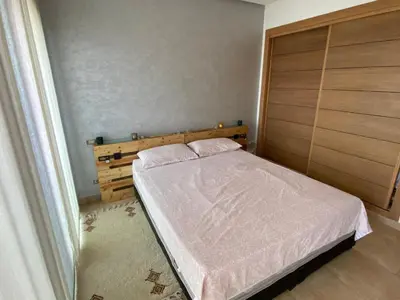 a bedroom with a bed with a wooden headboard at Rock island sablette in Pont Blondin