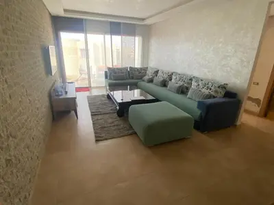 a living room with two couches and a table at Rock island sablette in Pont Blondin