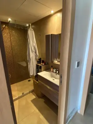 a bathroom with a shower and a sink and a tub at Rock island sablette in Pont Blondin