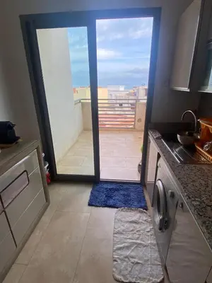 a kitchen with a door open to a balcony at Rock island sablette in Pont Blondin